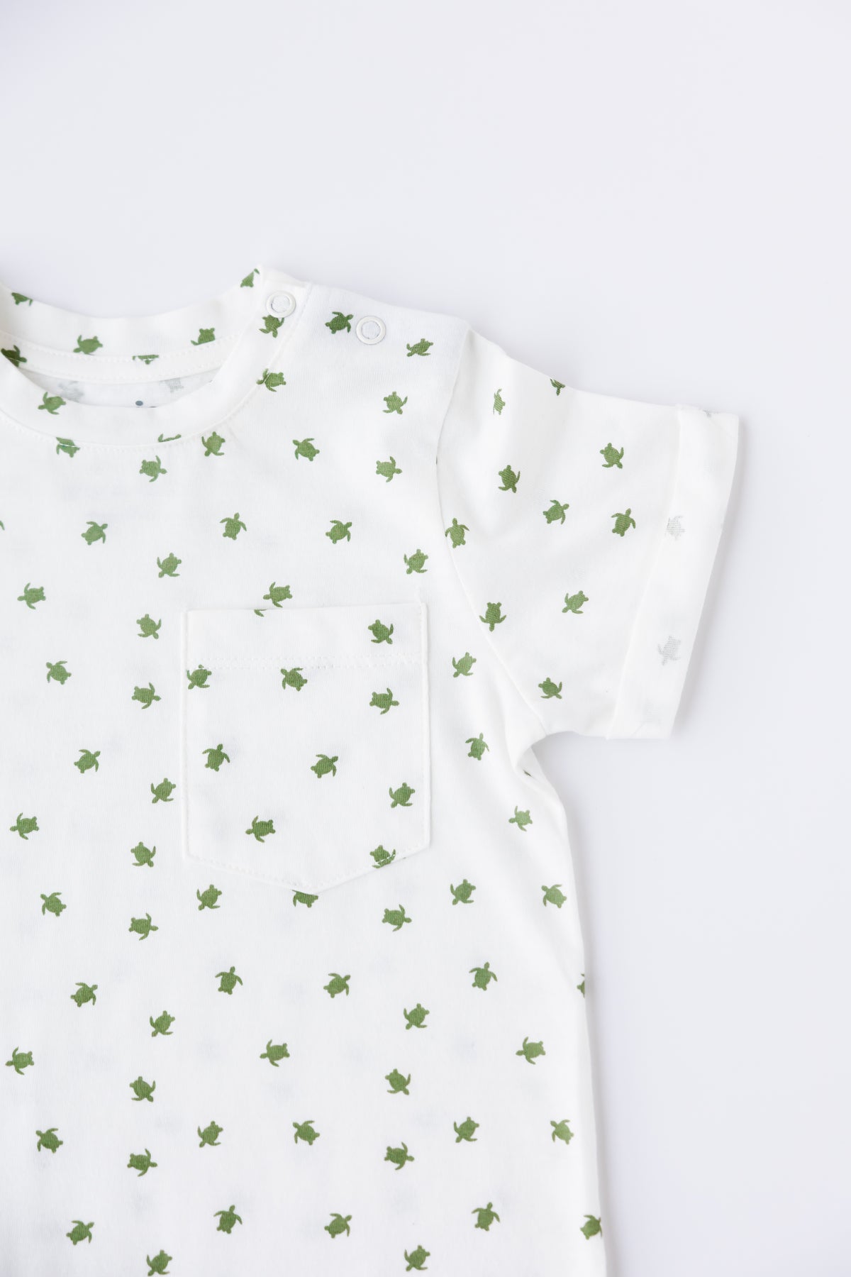 Close-up of the Turtle Bay print on the short sleeve romper