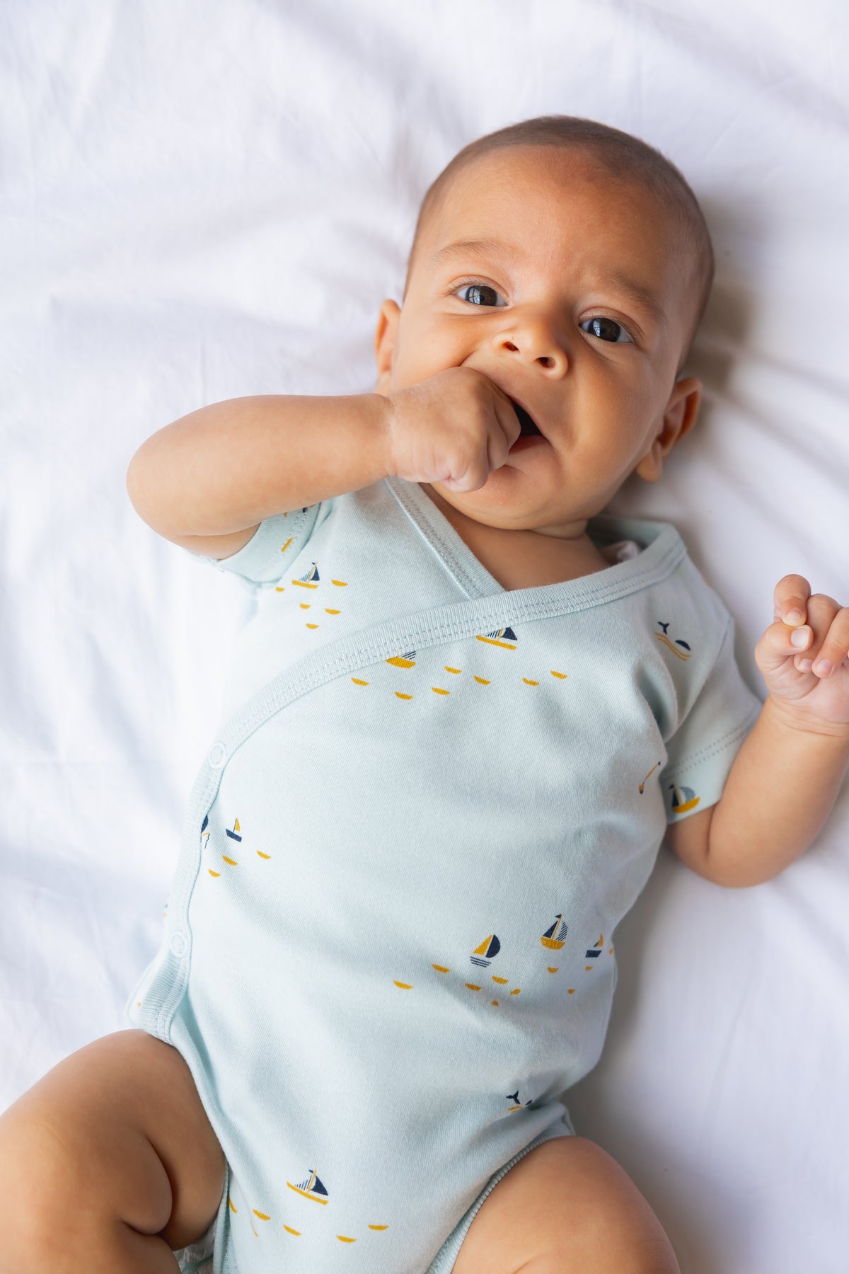 Baby yawning in a mint short sleeve kimono bodysuit