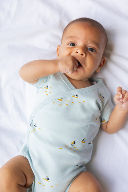 Baby yawning in a mint short sleeve kimono bodysuit