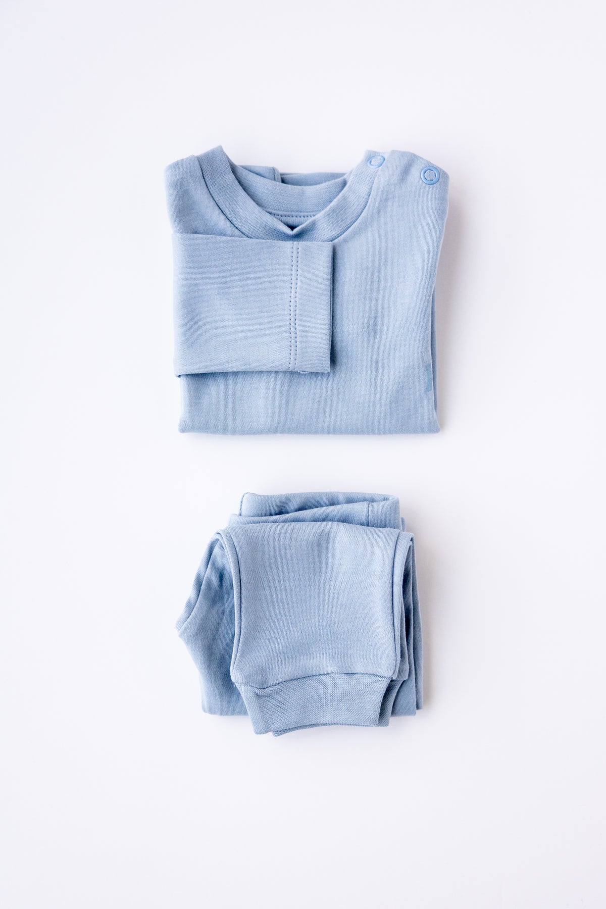 Dusty blue long sleeve pyjama top and pants, folded