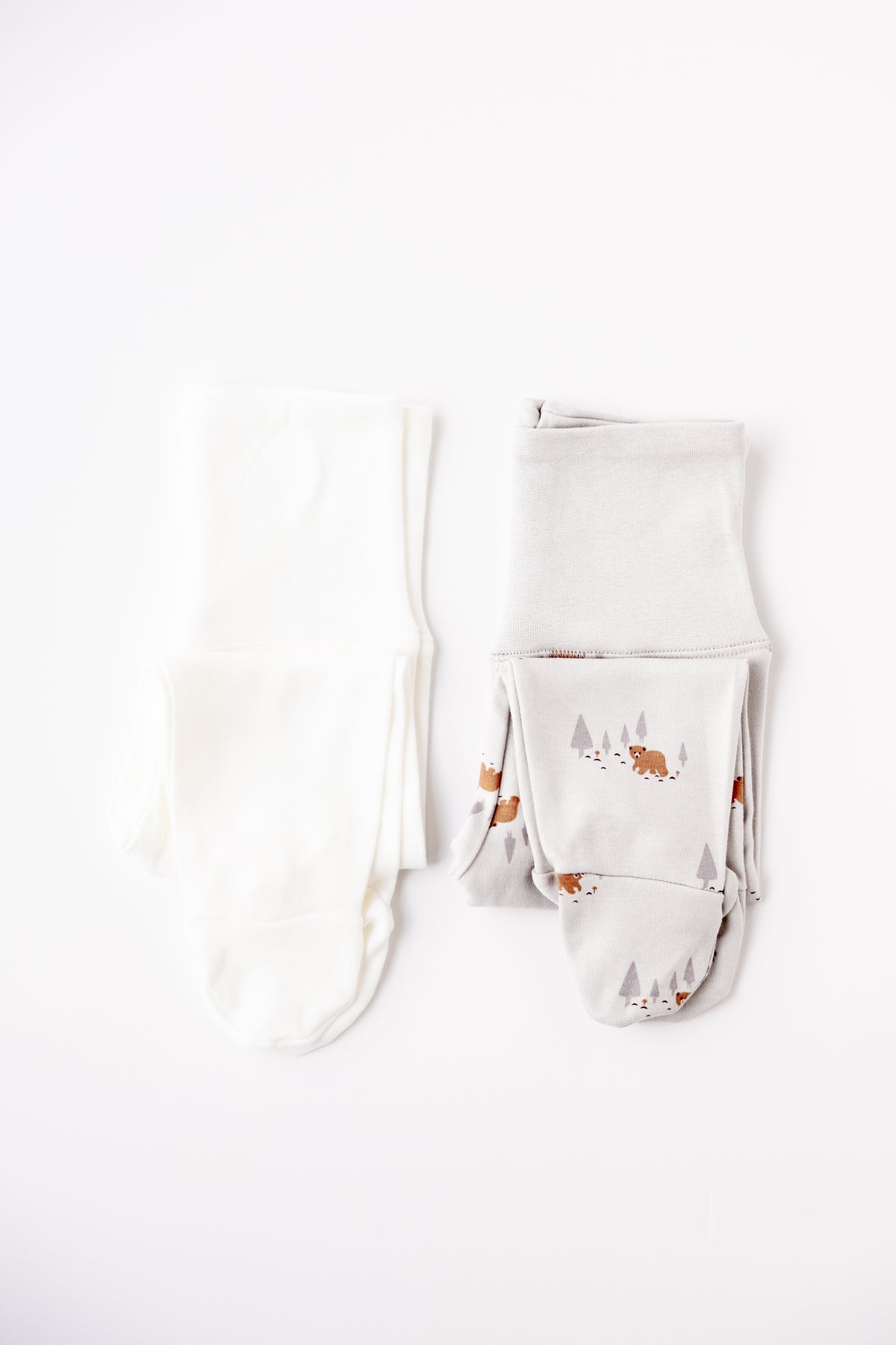 Two pairs of footed leggings in white and Woodland Bear print