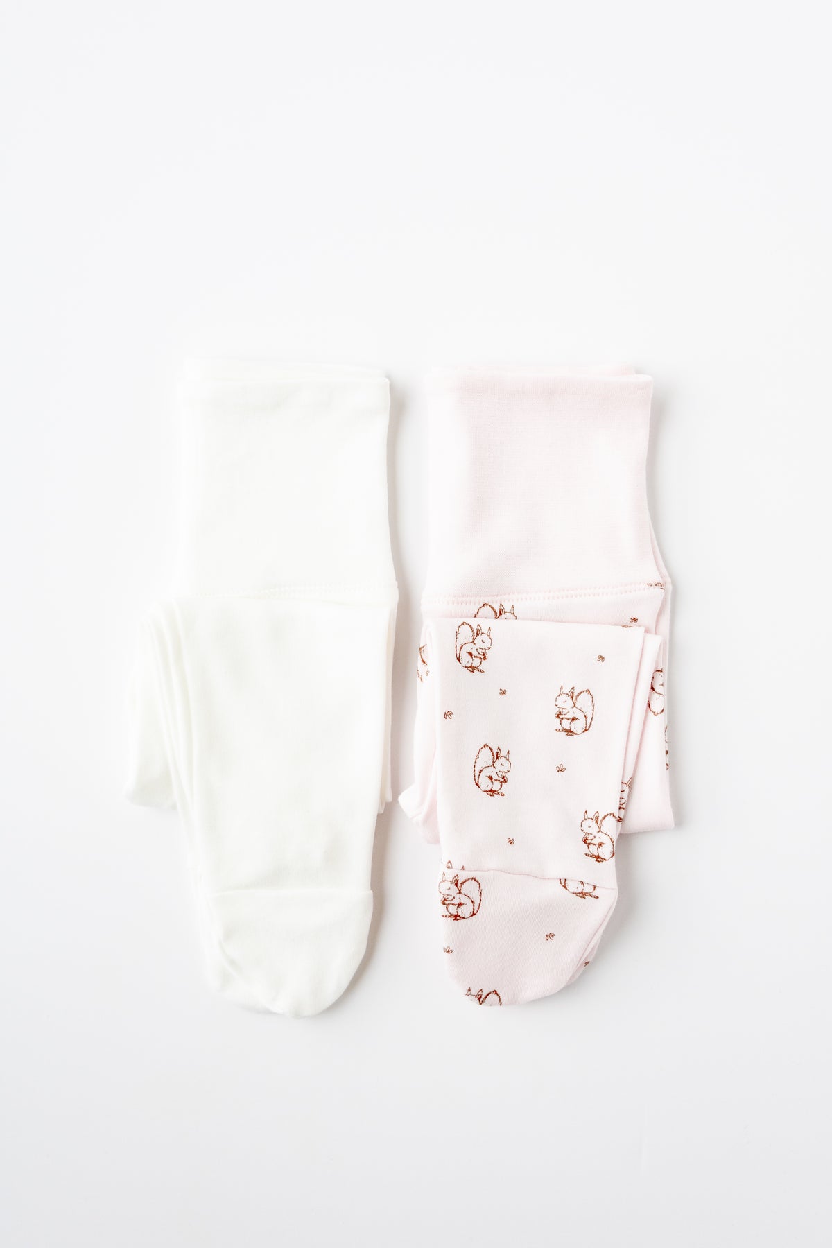 Two pairs of footed leggings in white and Forest Squirrel print