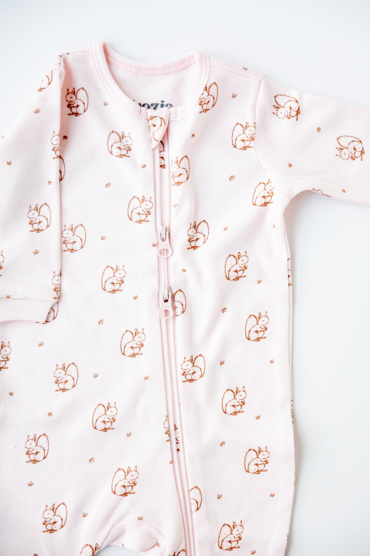 Forest Squirrel print zipper sleepsuit in blush, laid flat
