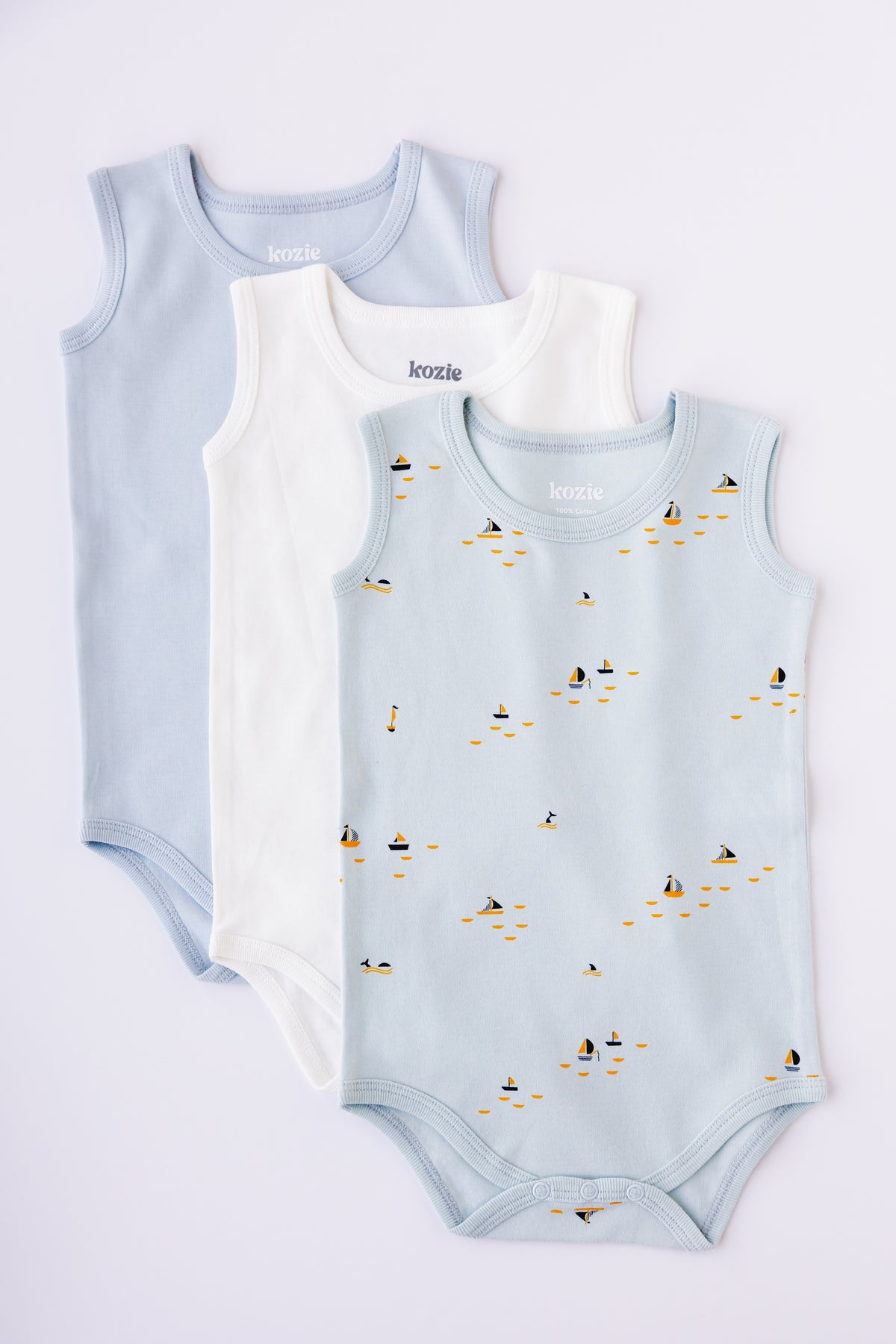 Three sleeveless bodysuits in sky blue, white and Blue Sails print