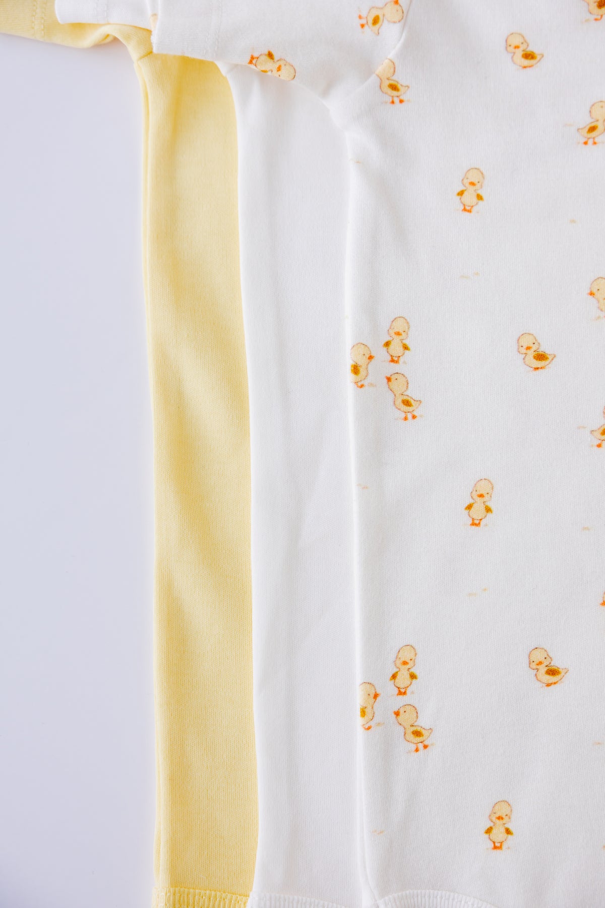 Close-up of the Ducky Days duck print on a white short sleeve bodysuit