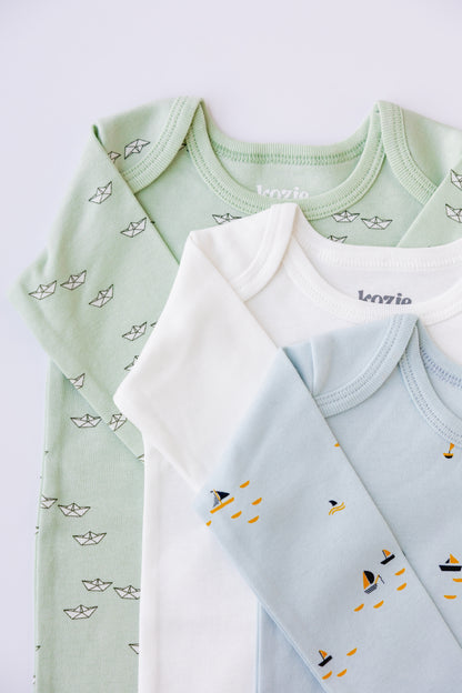 Sage, white and blue long sleeve bodysuits stacked, showing the boat print