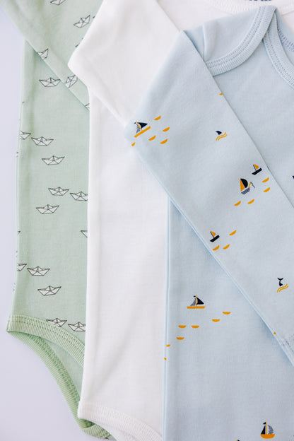 White and blue boat print long sleeve bodysuits laid flat