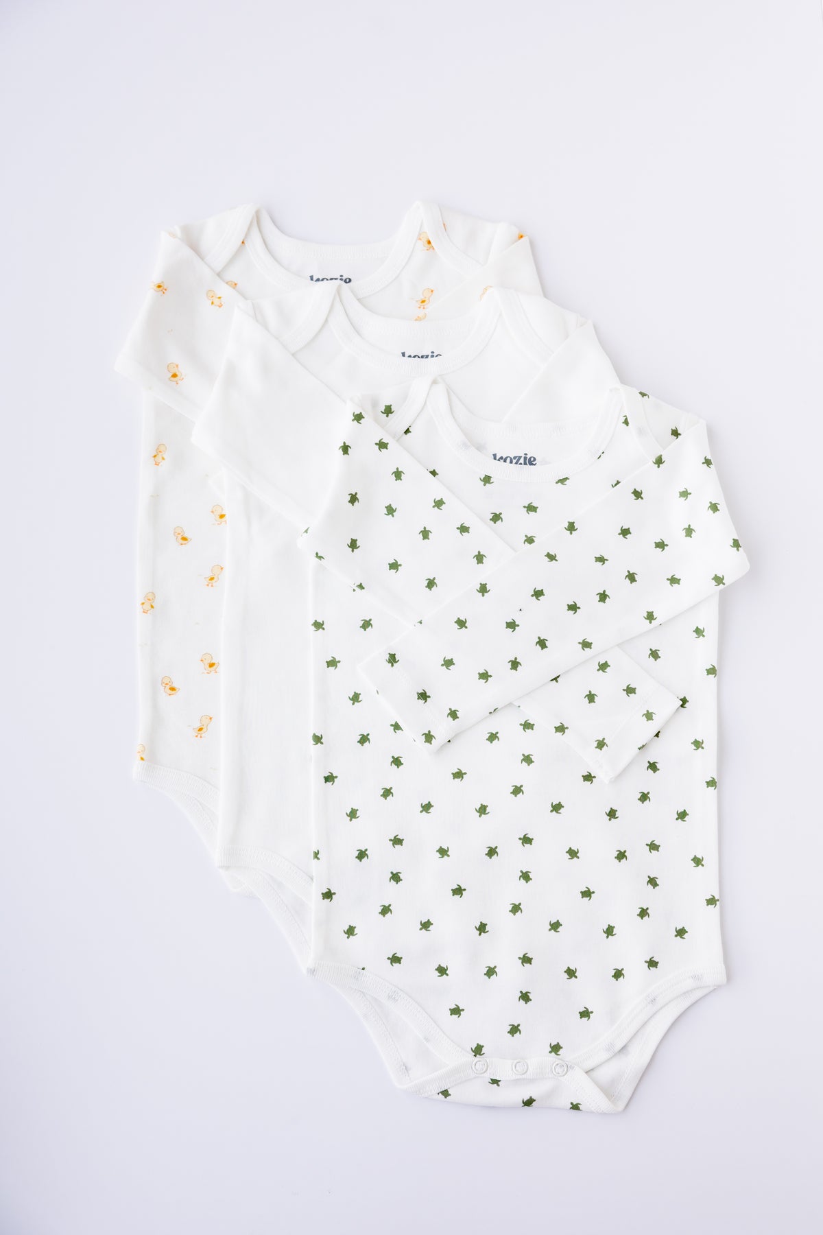 Tiny Explorer print long sleeve bodysuit, laid flat
