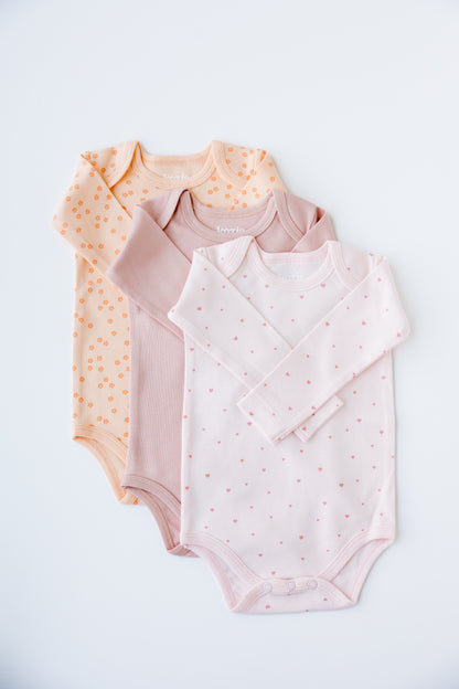 Three long sleeve bodysuits in blush, cream and Sweet Hearts print