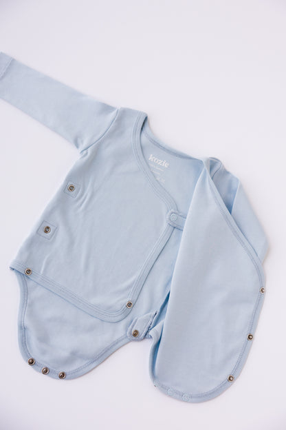 Close-up of the wrap front on a sky blue long sleeve kimono bodysuit