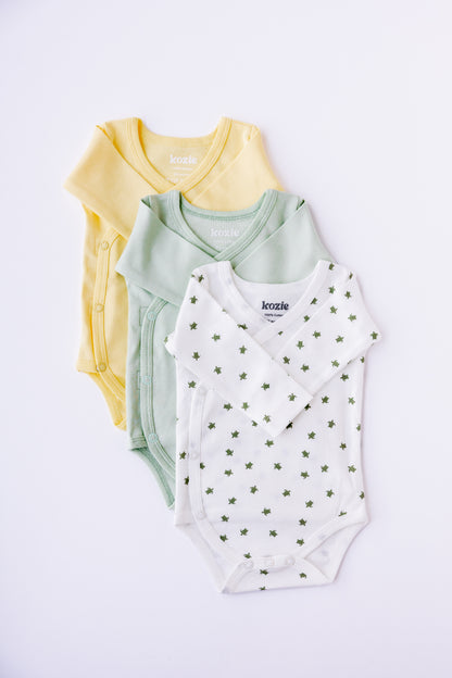 Three long sleeve kimono bodysuits in butter yellow, sage and Turtle Bay print