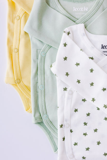 Turtle Bay print kimono bodysuit laid flat beside a sage pair
