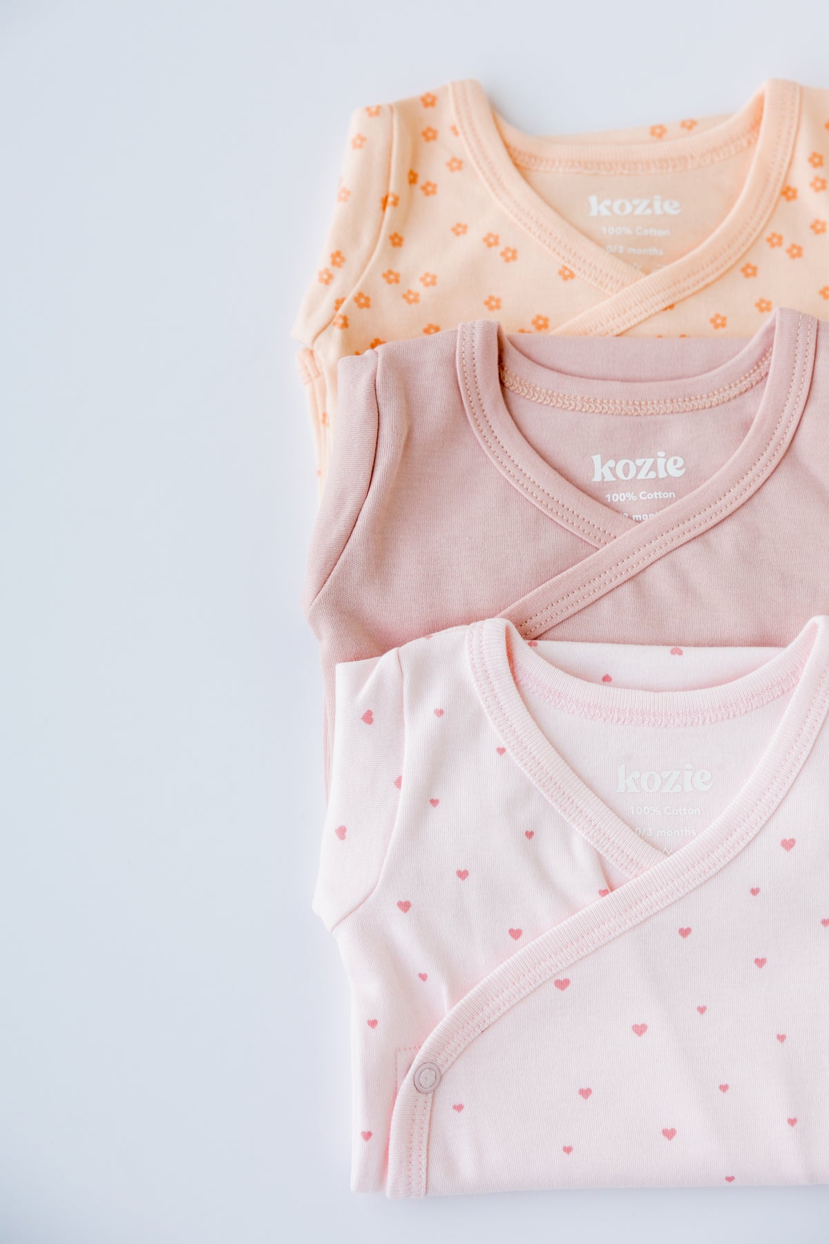 Close-up of the Sweet Hearts print on a blush kimono bodysuit