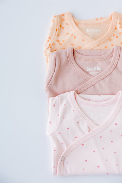 Close-up of the Sweet Hearts print on a blush kimono bodysuit