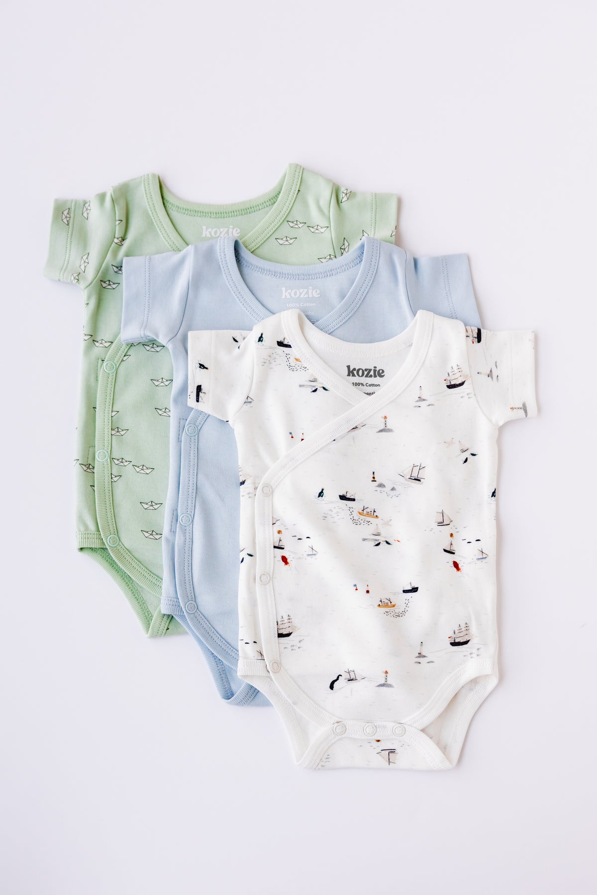 Three short sleeve kimono bodysuits in sage, white and Dreamy Voyage print