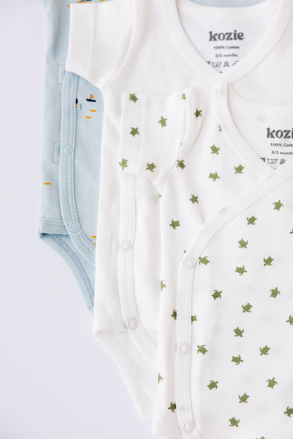 Sea Life kimono bodysuits folded and stacked in mint and white