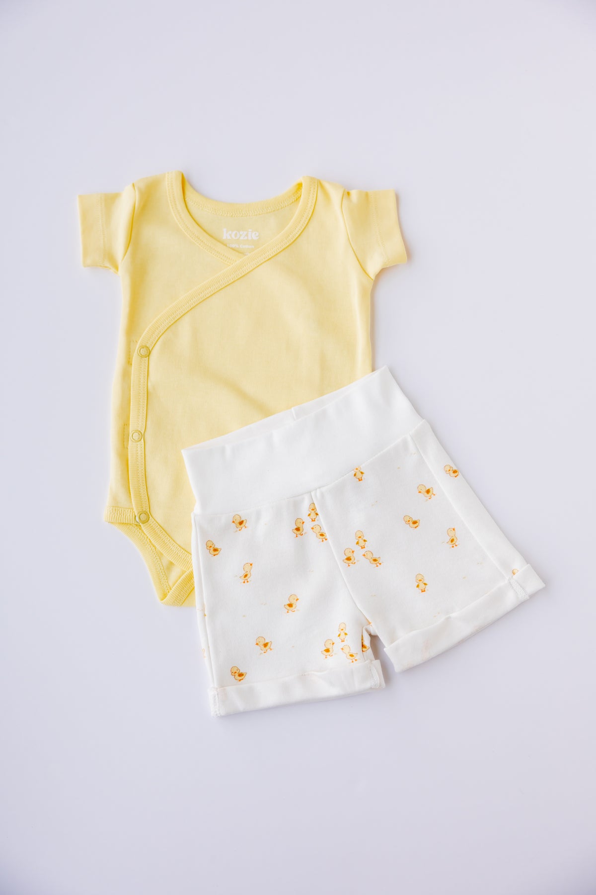 Butter yellow kimono bodysuit with Ducky Days duck print shorts, laid flat