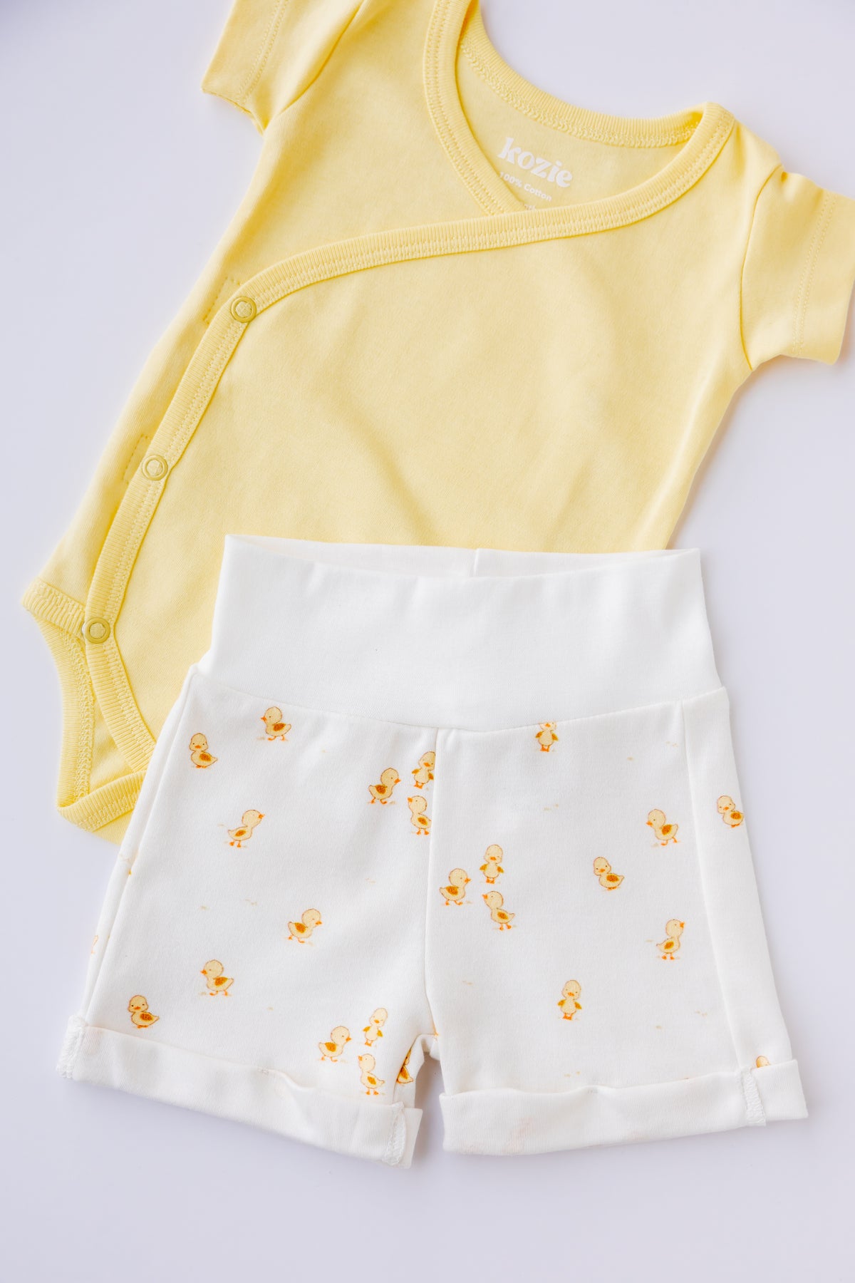Ducky Days kimono bodysuit and shorts set arranged on a pale background