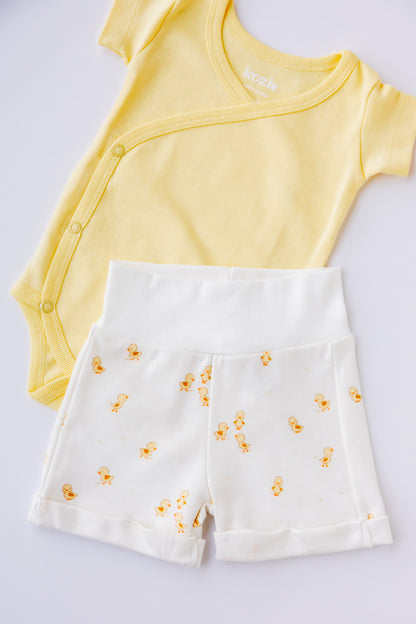 Ducky Days kimono bodysuit and shorts set arranged on a pale background