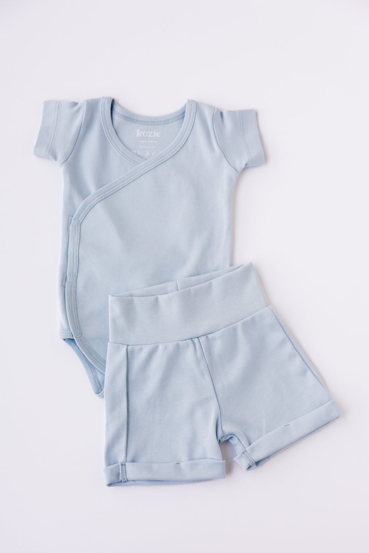 Sky blue kimono bodysuit with matching shorts, laid flat