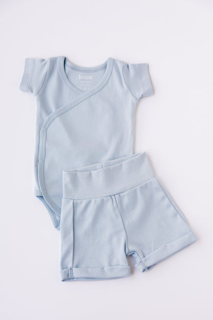 Sky blue kimono bodysuit with matching shorts, laid flat