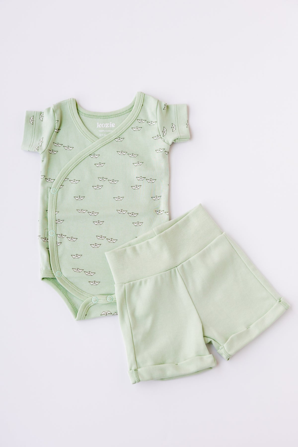 Mint kimono bodysuit with Paper Boats print shorts, laid flat