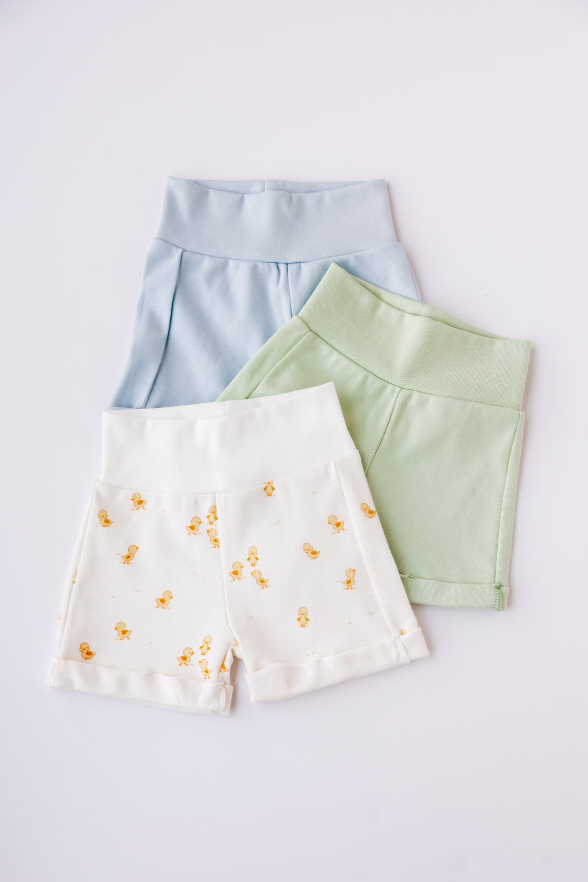 Three pairs of baby shorts in blue, sage and Ducky Days duck print