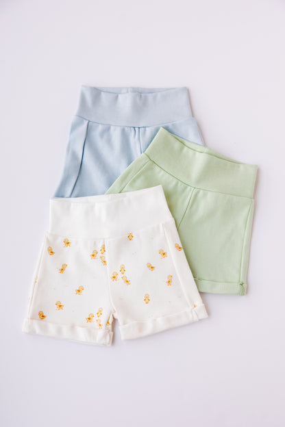 Three pairs of baby shorts in blue, sage and Ducky Days duck print