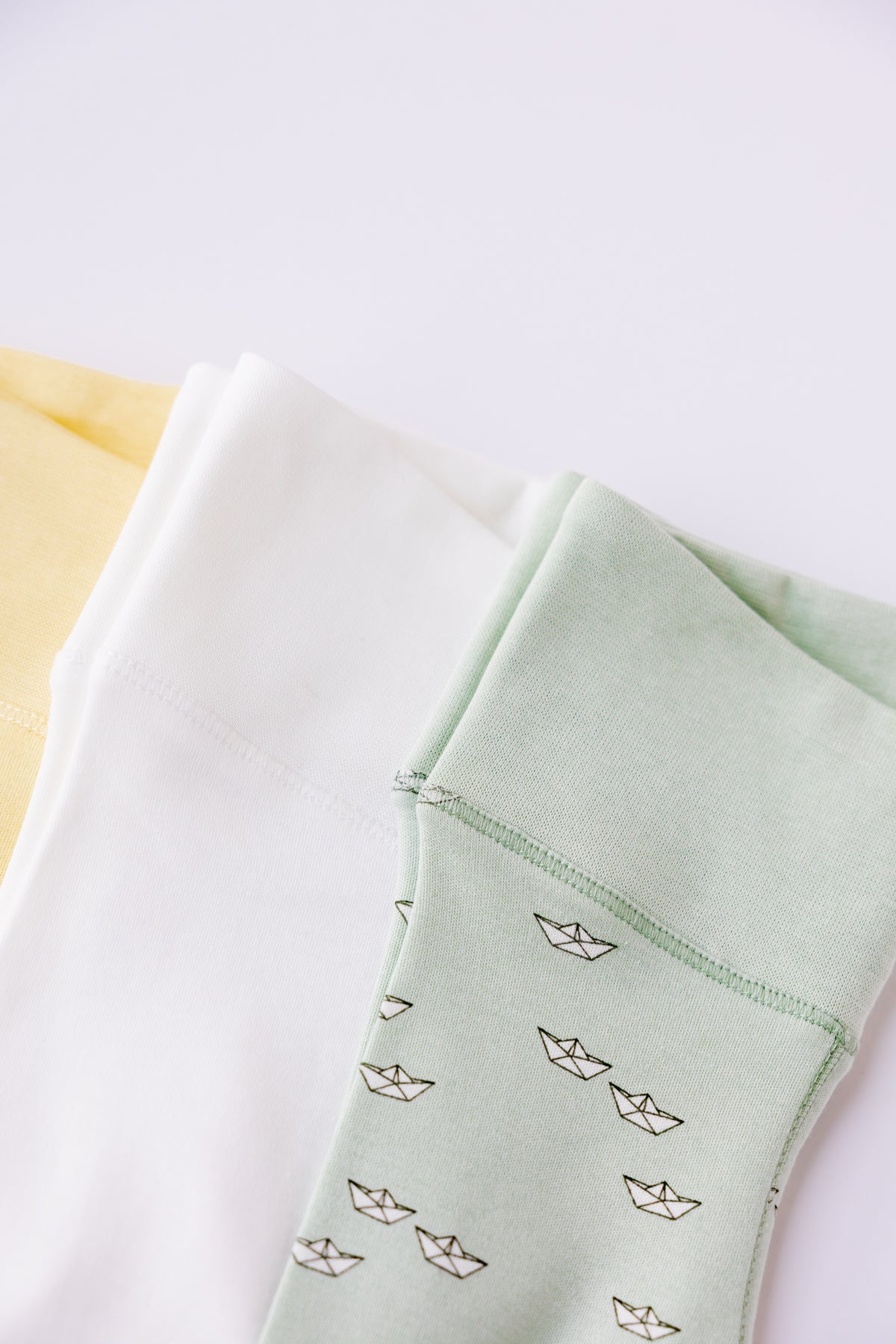 Close-up of the sage footed leggings from the Paper Boats set
