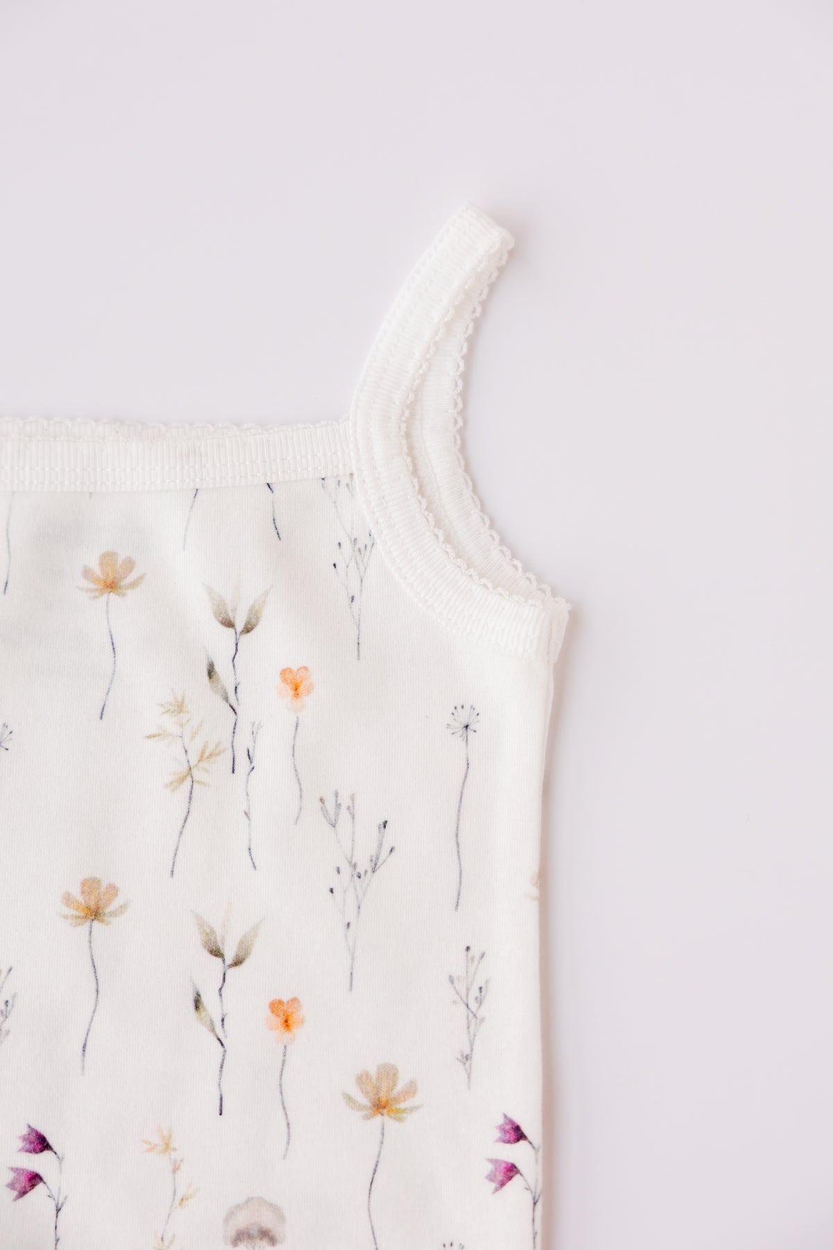 White Wild Flowers print sleeveless bodysuit laid flat