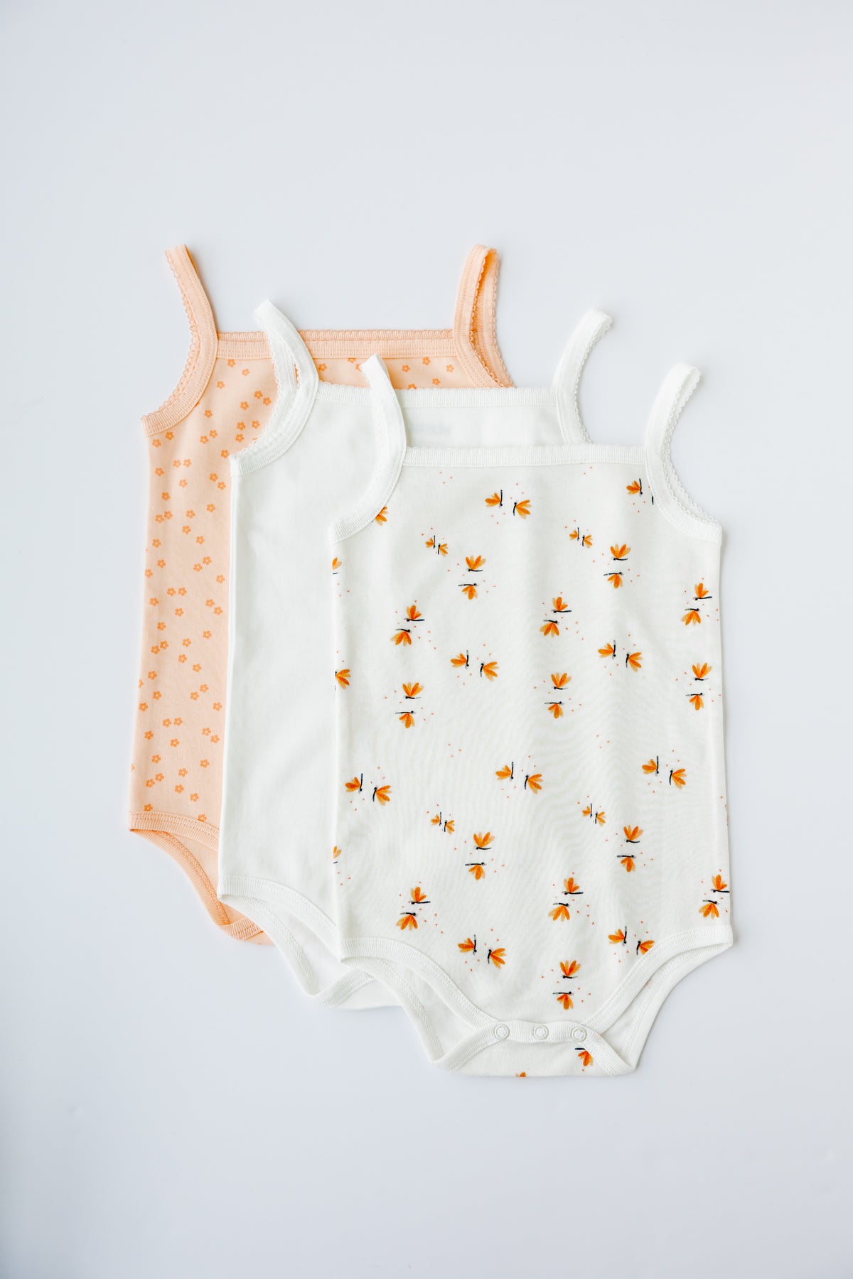 Daisy Dreams print sleeveless bodysuit, laid flat