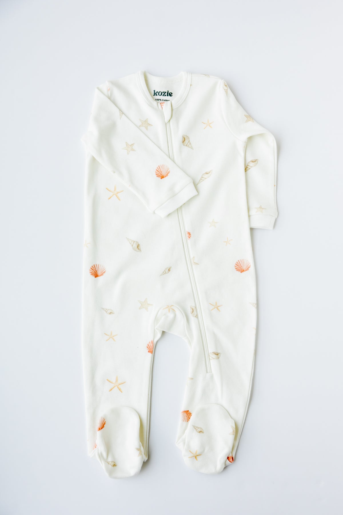Sea Shells print footed zipper sleepsuit in white, laid flat
