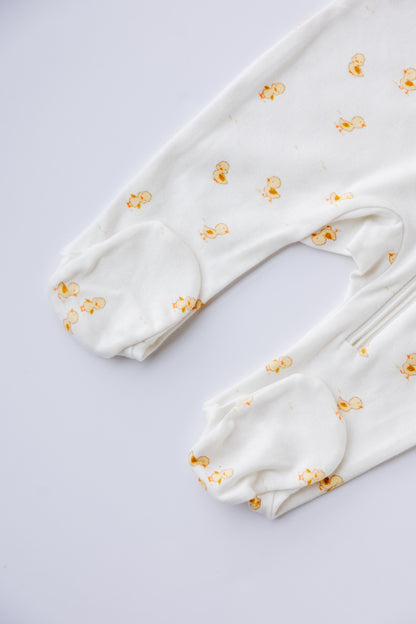 Close-up of the Ducky Days duck print on the white sleepsuit