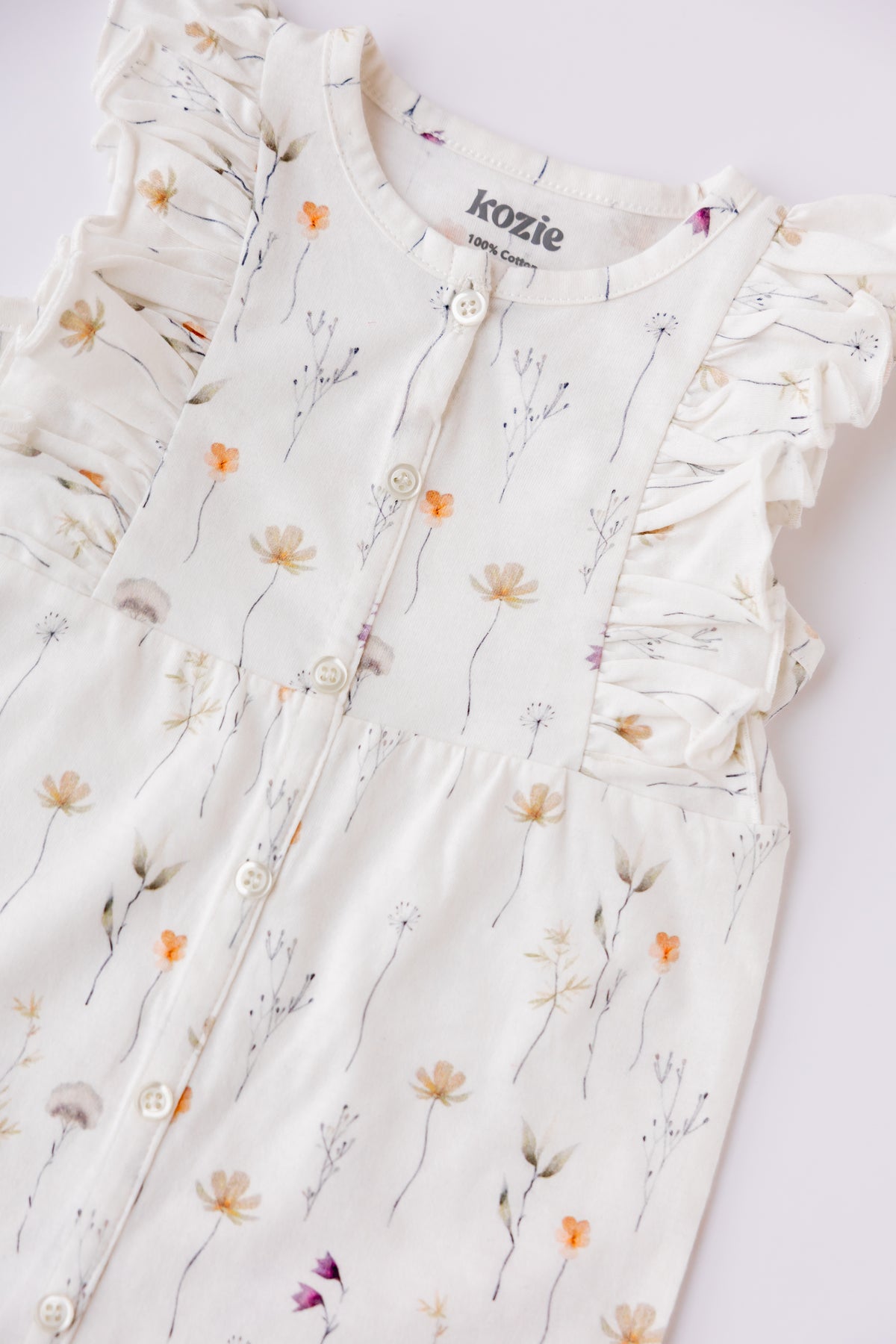 Close-up of the Wildflower print and ruffle detail on the romper