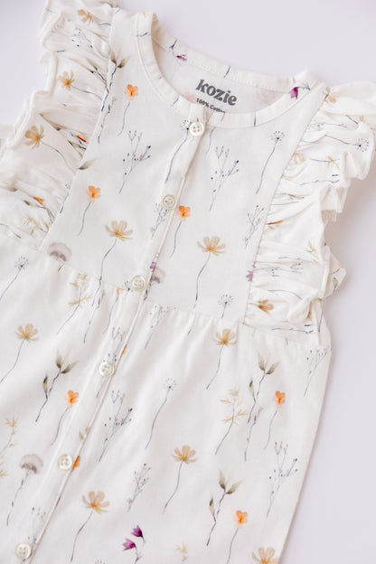 Close-up of the Wildflower print and ruffle detail on the romper