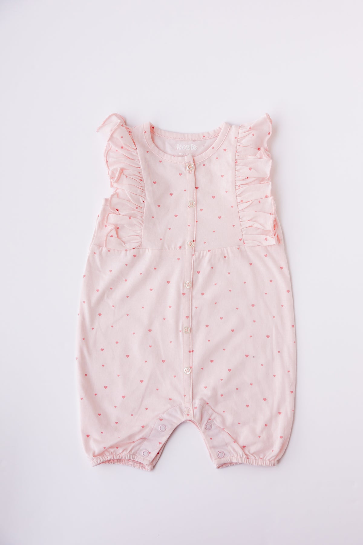 Blush Tiny Love print ruffle romper, laid flat