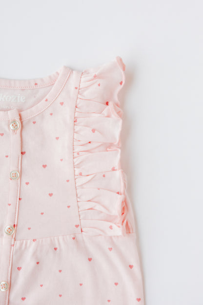 Close-up of the ruffle front on the blush Tiny Love romper
