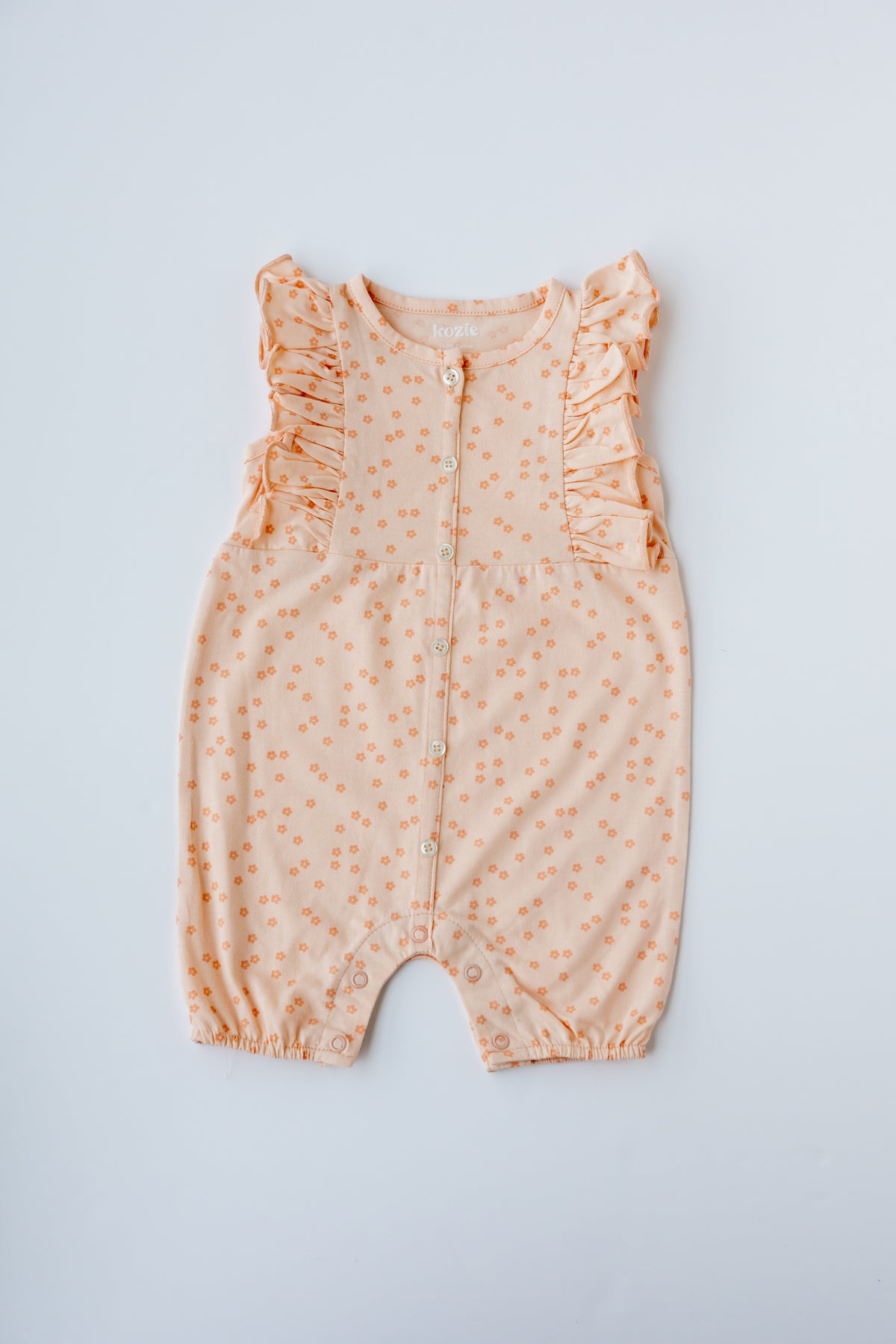 Coral Daisies print ruffle romper, laid flat