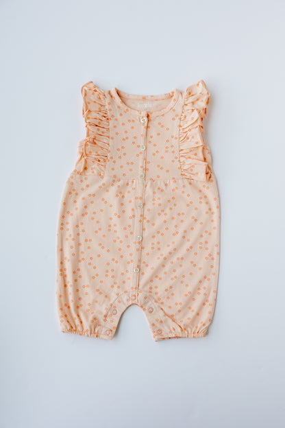 Coral Daisies print ruffle romper, laid flat