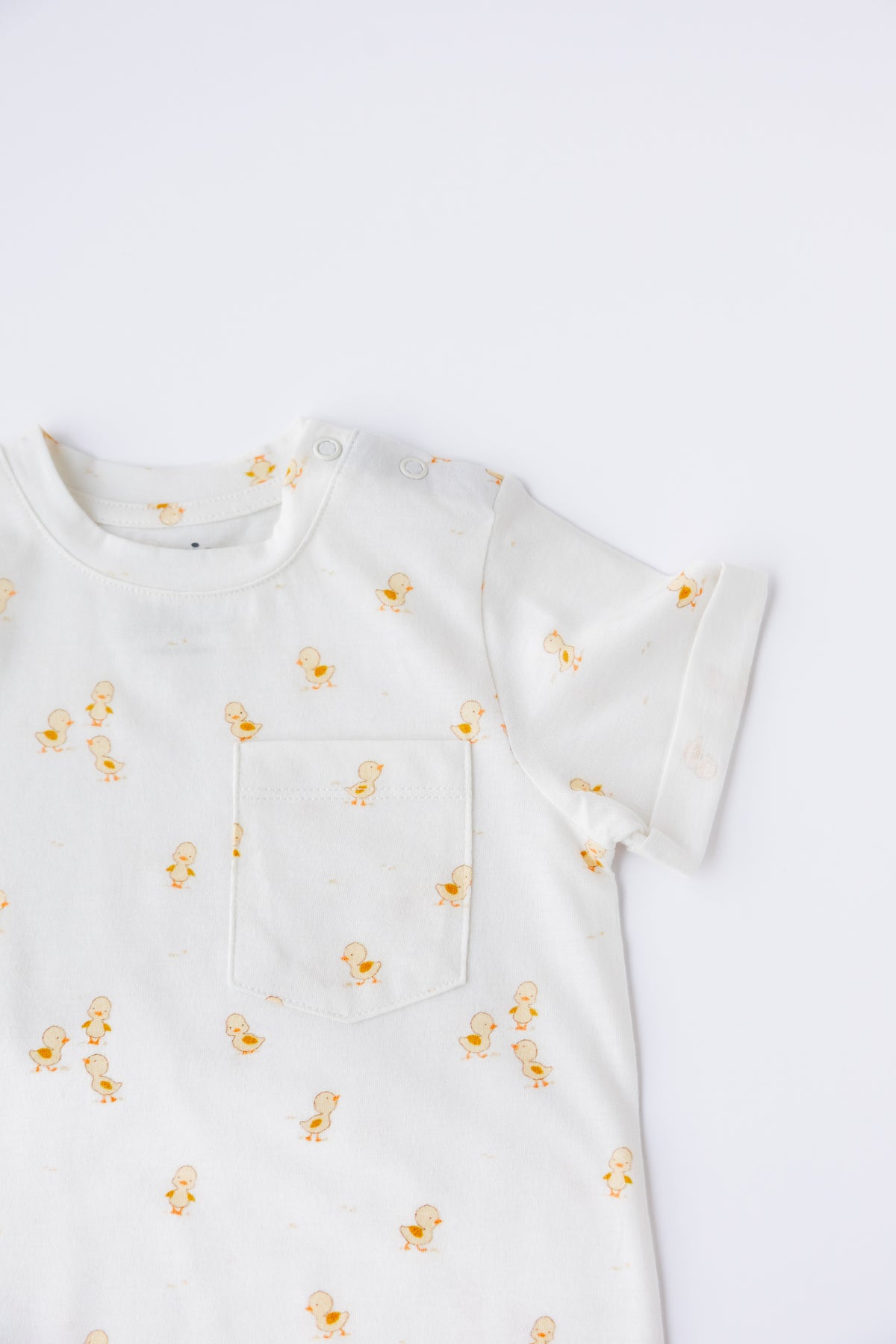 Close-up of the Ducky Days duck print on the short sleeve romper