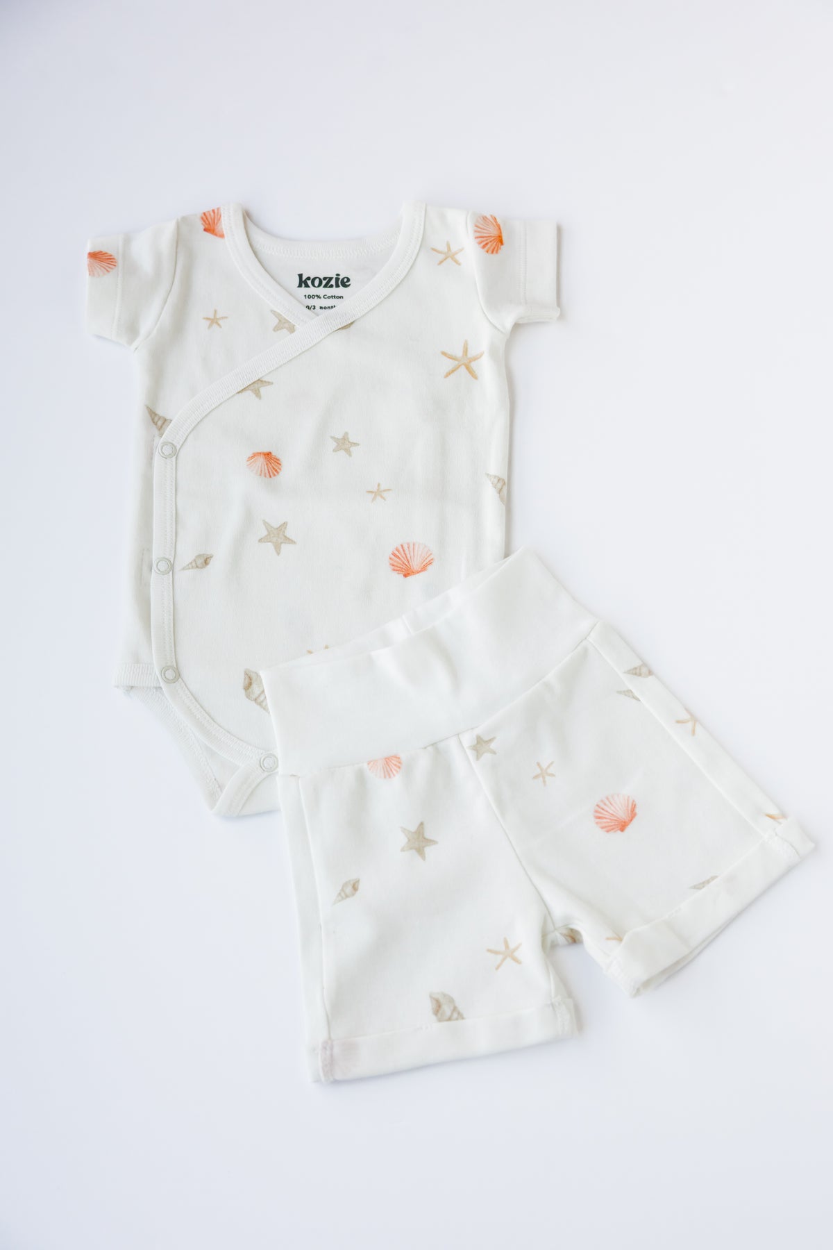 Sea Shells kimono bodysuit and shorts, laid flat