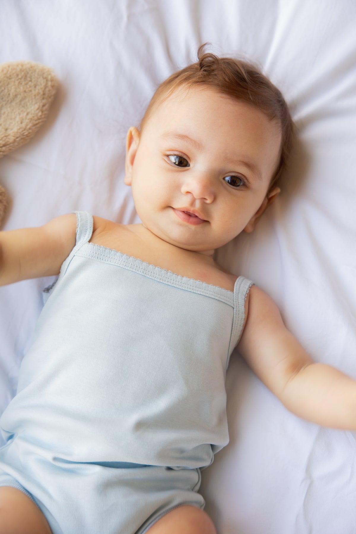 Baby wearing a Kozie sleeveless bodysuit