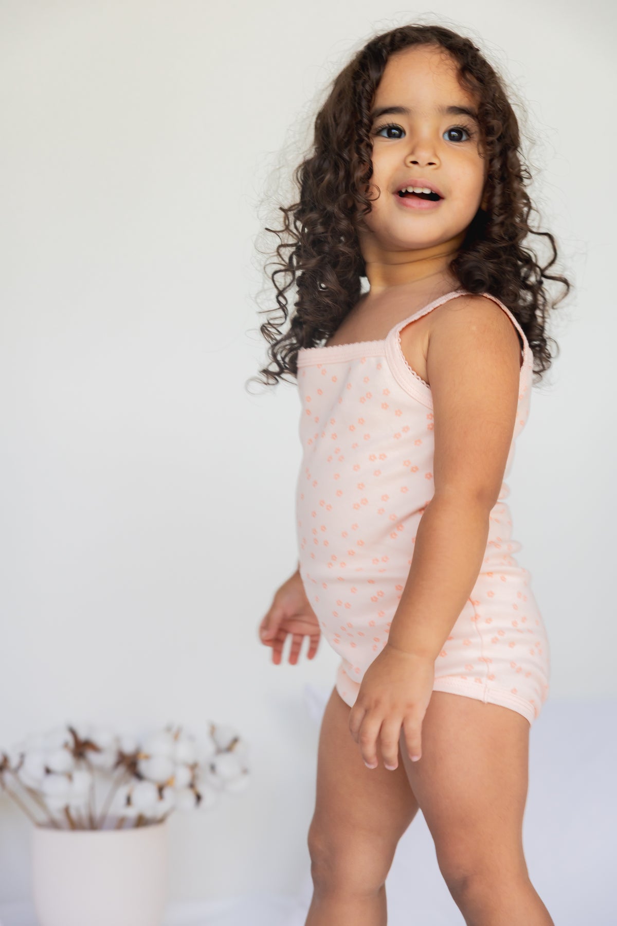 Toddler standing in the Daisy Dreams sleeveless bodysuit