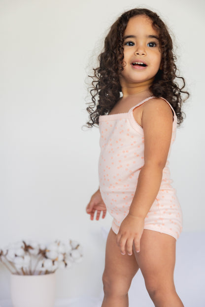 Toddler standing in the Daisy Dreams sleeveless bodysuit