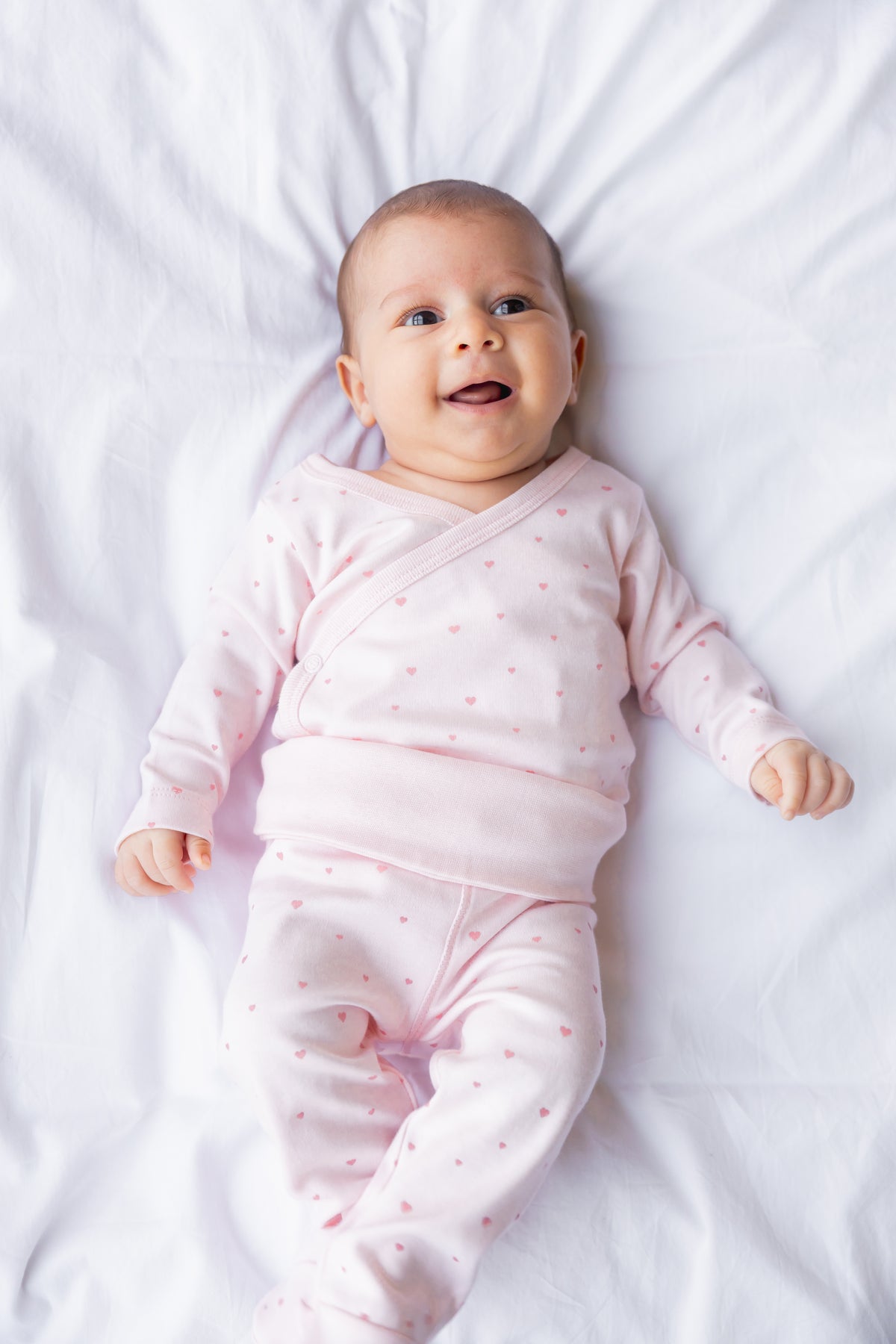 Baby resting in a blush long sleeve kimono bodysuit