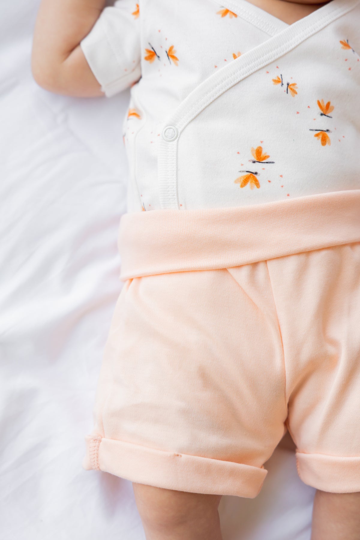 Close-up of the peach Sea Shells baby shorts