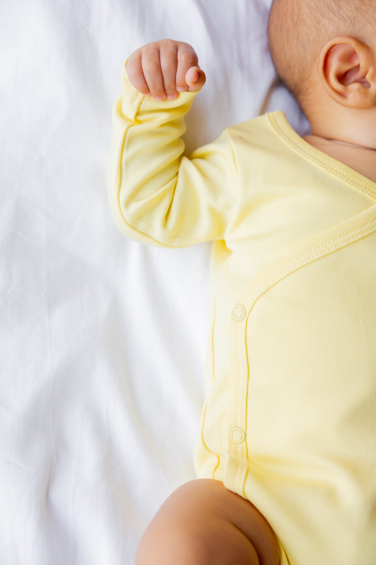 Baby in a butter yellow long sleeve kimono bodysuit