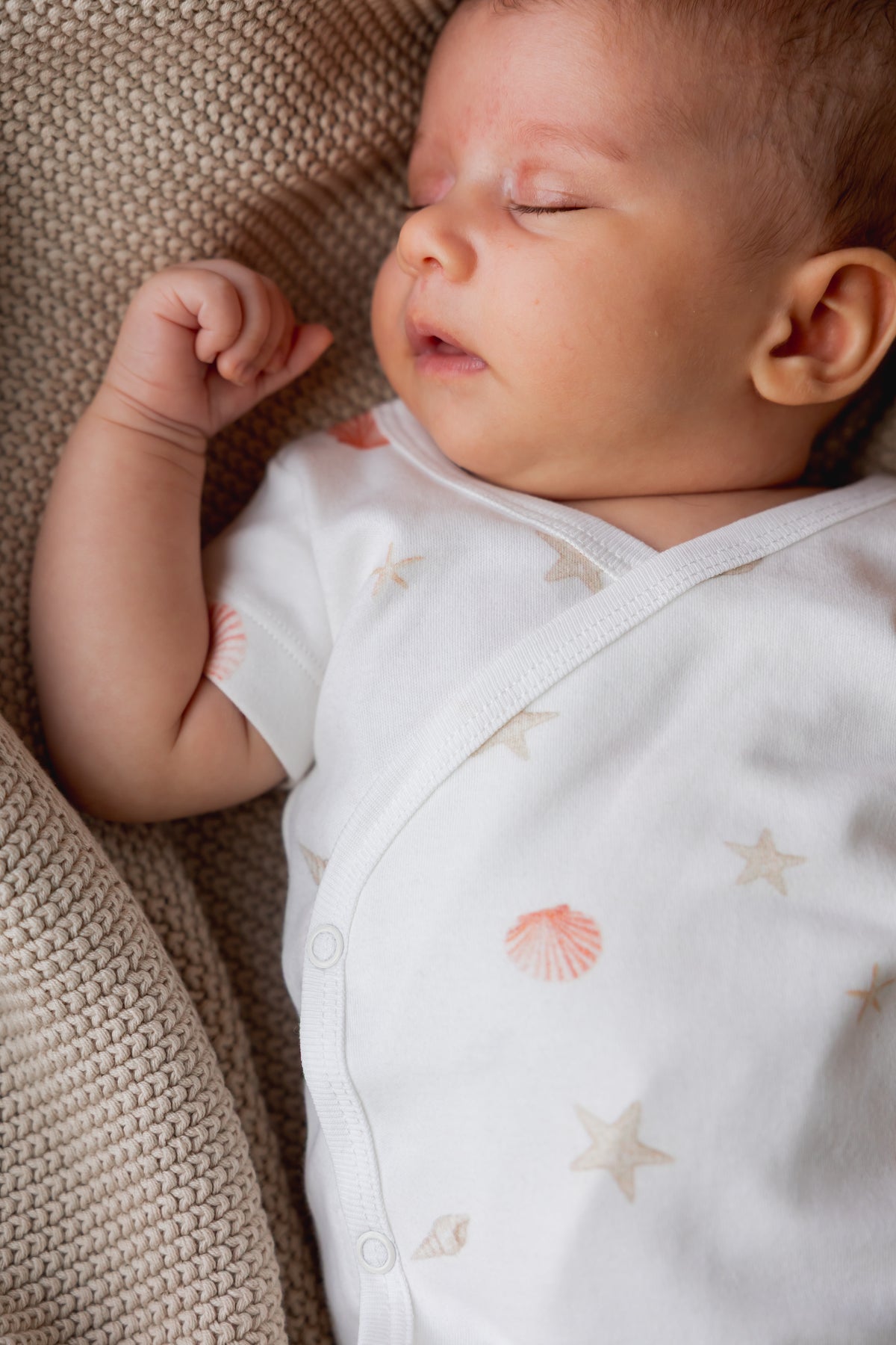 Close-up of a sleeping newborn in the Sea Shells kimono set