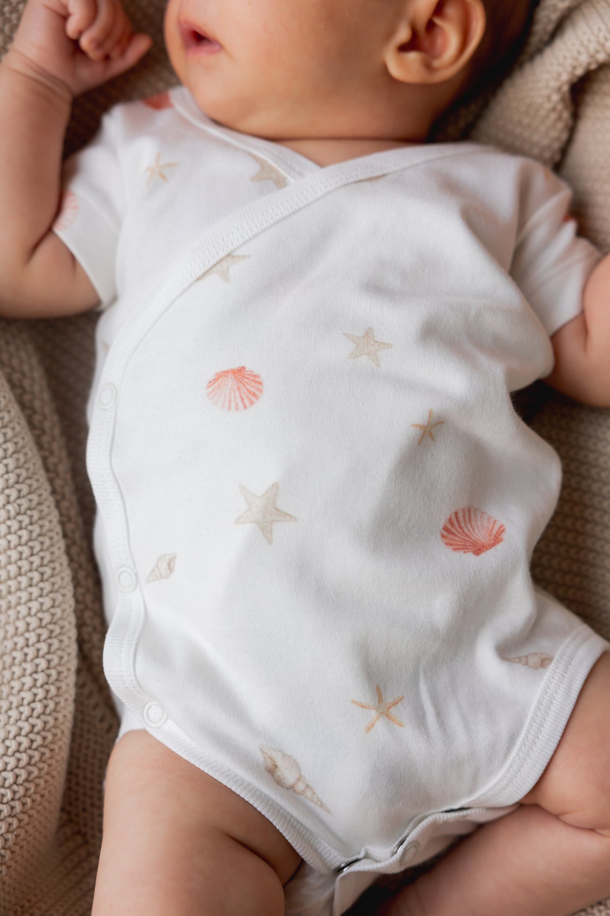 Baby wearing a white short sleeve kimono bodysuit