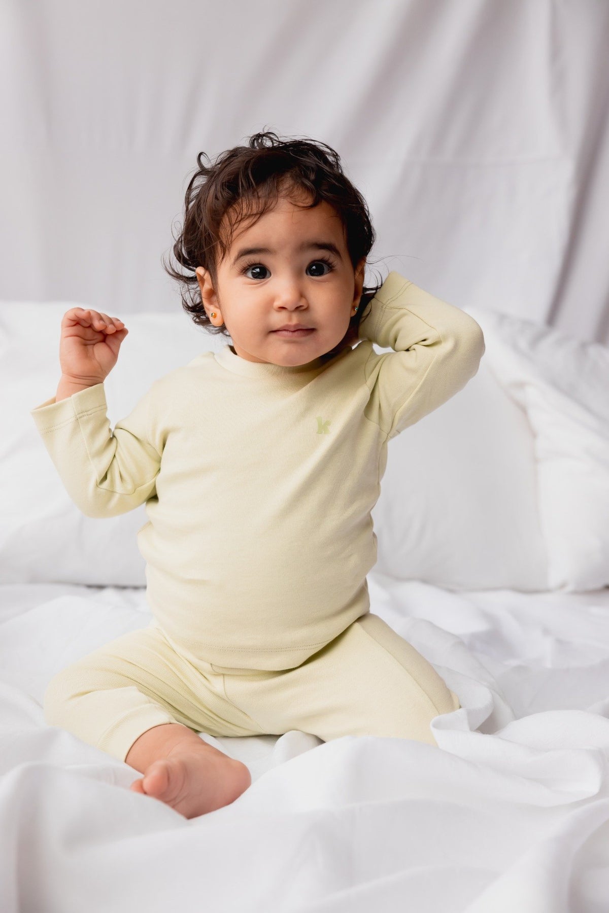 Baby sitting in the sage long sleeve pyjama set
